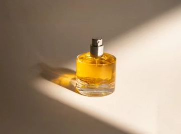 a bottle of perfume sitting on a white surface
