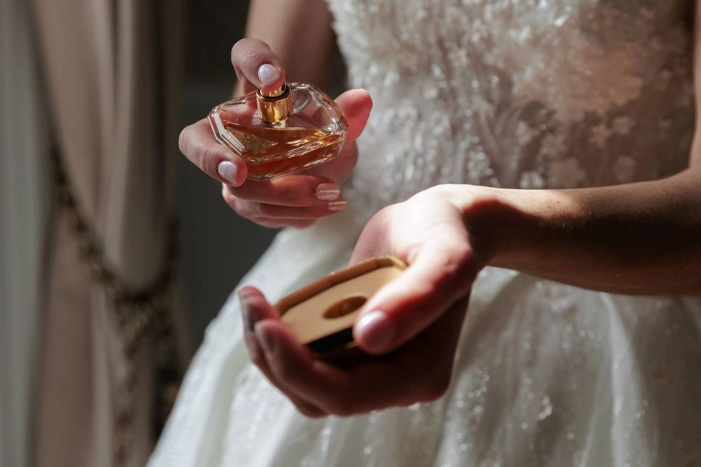 the woman is applying perfume