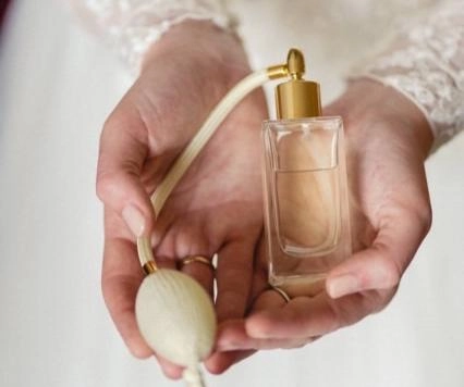 a woman holding a perfume
